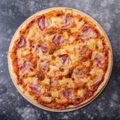 Pizza Hawaiian on dark stone. square photo. top view flat lay background. pineapple