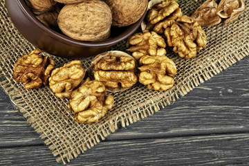 Walnuts on rustic table in clay bowl. Walnut kernels. Walnut healthy food.