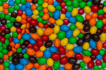Sweet bonbon colorful candy of different size and color, texture or background. top view, horizontal