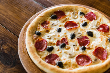 delicious pizza with meat, cheese and mushrooms	