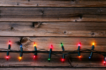 Christmas garland lights on brown wooden table