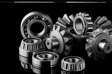 Gears, bearings and differential stars lie on the table close-up