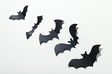 Halloween paper bats on white background