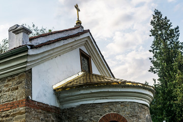 An old Christian Balkan church with stone walls and a golden cross. Orthodox church in Stara...