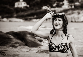 portrait of the beautiful young woman with the diving mask in the sea in Greece. Image in black and white color style
