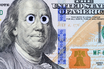 Portrait of Benjamin Franklin from the one hundred dollar banknote with strange eyes