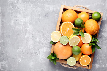 Citrus fruits in tray on wooden table
