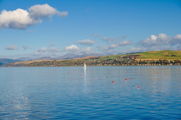 Looking over to Dunoon from the front at Gourock and a single Yacht in between.