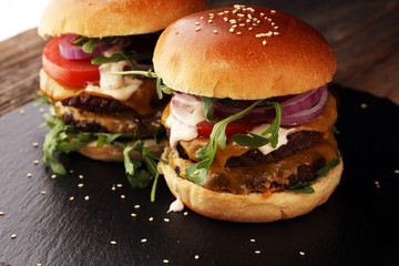 Tasty fresh meat burgers with salad and cheese. Homemade angus burger.