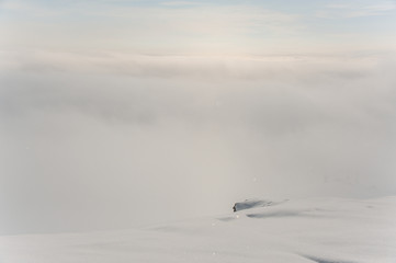 Pure cloud on the high mountain peak on winter day