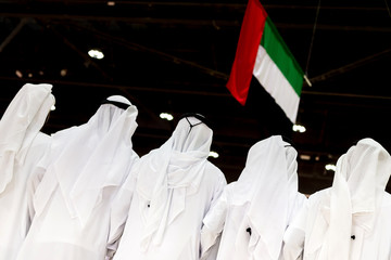 Emirati unrecognisable men looking at the UAE flag, concept of patriotism and celebration of the...