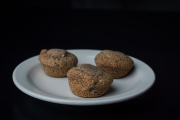 Three mini-muffins on a white plate