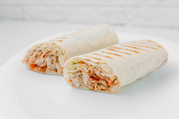 Shawarma sandwich - fresh roll of thin lavash (pita bread) filled with grilled meat, mushrooms,...