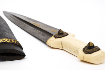 Oriental dagger with a handle from a bone sheath on a white background.