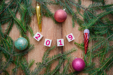 New year 2019, the number on cubes on a wooden background