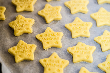 Christmas baking. Making gingerbread biscuits. Cookie star shape on kitchen counter.