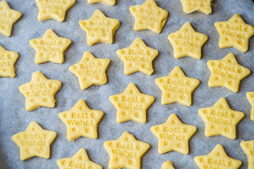 Christmas baking. Making gingerbread biscuits. Cookie star shape on kitchen counter.