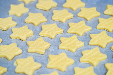 Christmas baking. Making gingerbread biscuits. Cookie star shape on kitchen counter.