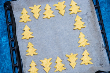 Christmas baking. Making gingerbread biscuits. Cookie star shape on kitchen counter.