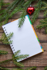 New Year picture with Christmas tree branches and a notebook