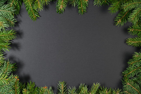 New Year's black background. spruce branches on the table