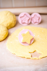 Christmas baking. Making gingerbread biscuits. Cookie star shape on kitchen counter.