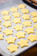 Christmas baking. Making gingerbread biscuits. Cookie star shape on kitchen counter.