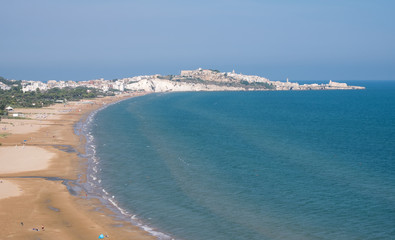 Fototapeta na wymiar Coastline of the Gargano Peninsula in Puglia, southern Italy, with the town of Vieste on the horizon. Photographed on a clear day in late summer.