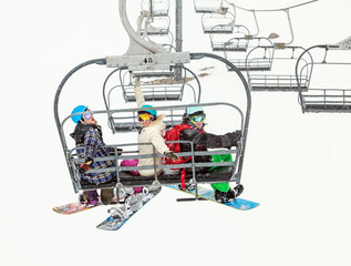 Three friends of snowboarders in mountains