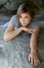 Smiling Woman Lying Across Boulder