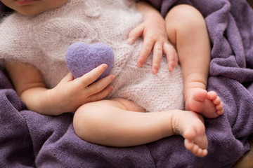 Obraz na płótnie Canvas newborn child. a small child with a toy heart