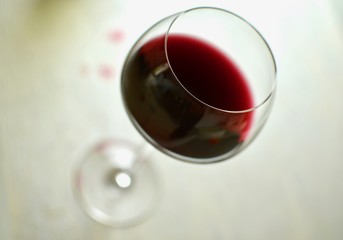 Top view of an elegant glass of red wine on white background