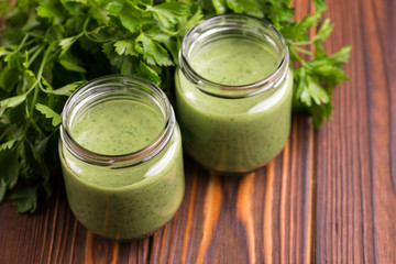 Fresh spinach and avocado smoothie in glass jars