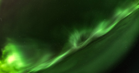 Close up high definition photo of very bright green aurora with stars shining behind it, taken in north Sweden, no clouds, very good for backgrounds