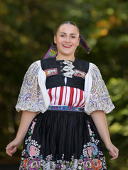 Young beautiful slovak woman in traditional costume. Slovak folklore.