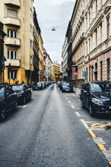 Street with cars and old buildings in the historical district of Budapest city, Hungary