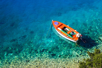 Boat on crystal clear water. The photo was taken on the Ionian island of Kefalonia in Greece
