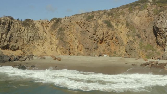 Aerial panning shot of a private beach