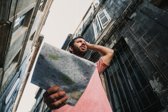 .Young tourist walking the streets of Bordeaux, in France. Using a map because it is lost in the city. Travel Photography. Lifestyle.