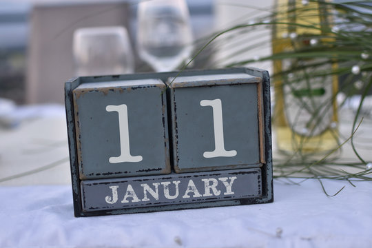 Wood blocks in box with date, day and month 11 January. Wooden blocks calendar