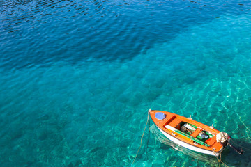 Boat on crystal clear water. The photo was taken on the Ionian island of Kefalonia in Greece