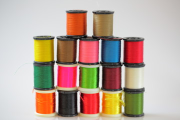 Colorful spools of thread closeup view isolated. Hobby backgrounds. Sewing supplies concept.