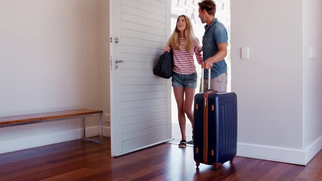 Couple Arriving At Summer Vacation Rental