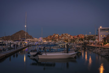 Various boats and yachts moored at the marina at night in Los Cabos, Baja California, Mexico
