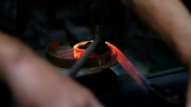 Blacksmith shaping the molten metal 4k