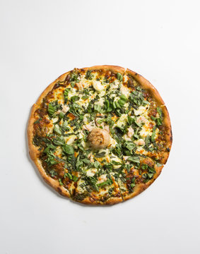 Whole pizza over white surface.
