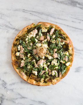 Whole pizza over marble surface.