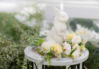 White rabbit statue with flower on white table