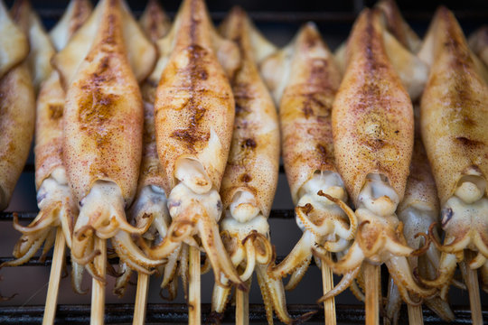Grilled calamari on a stick in a Cambodian Market.