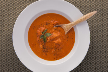 Hot red pepper soup with a spoon in it.